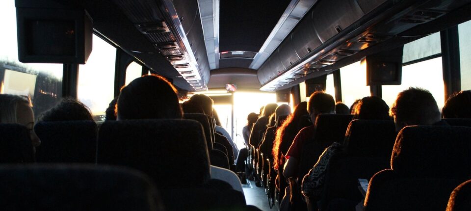 people riding passenger bus during daytime